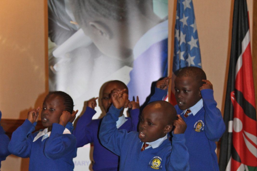 First grade pupils in uniform taking part in class